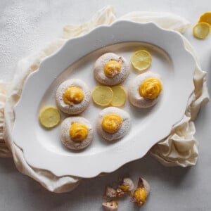 little lemon meringue on white platter with lemon slices