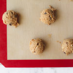 Bourbon and dark chocolate cookie dough on a silpat mat and baking sheet