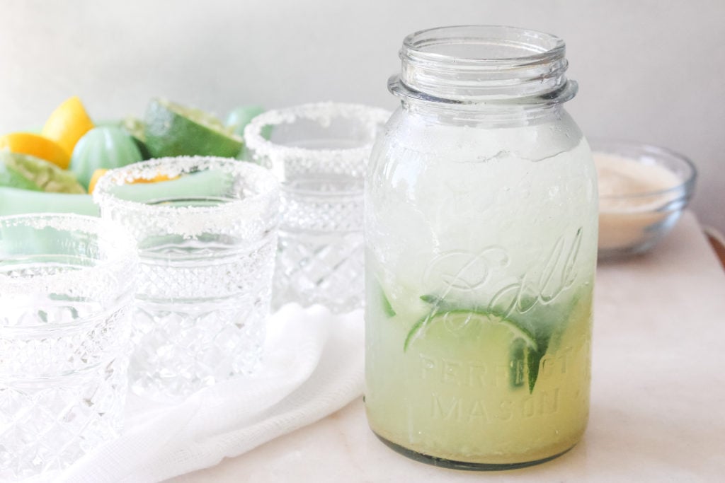 Fresh margaritas in a mason jar made with lime, lemons, tequila, triple sec and plenty of frosty ice.