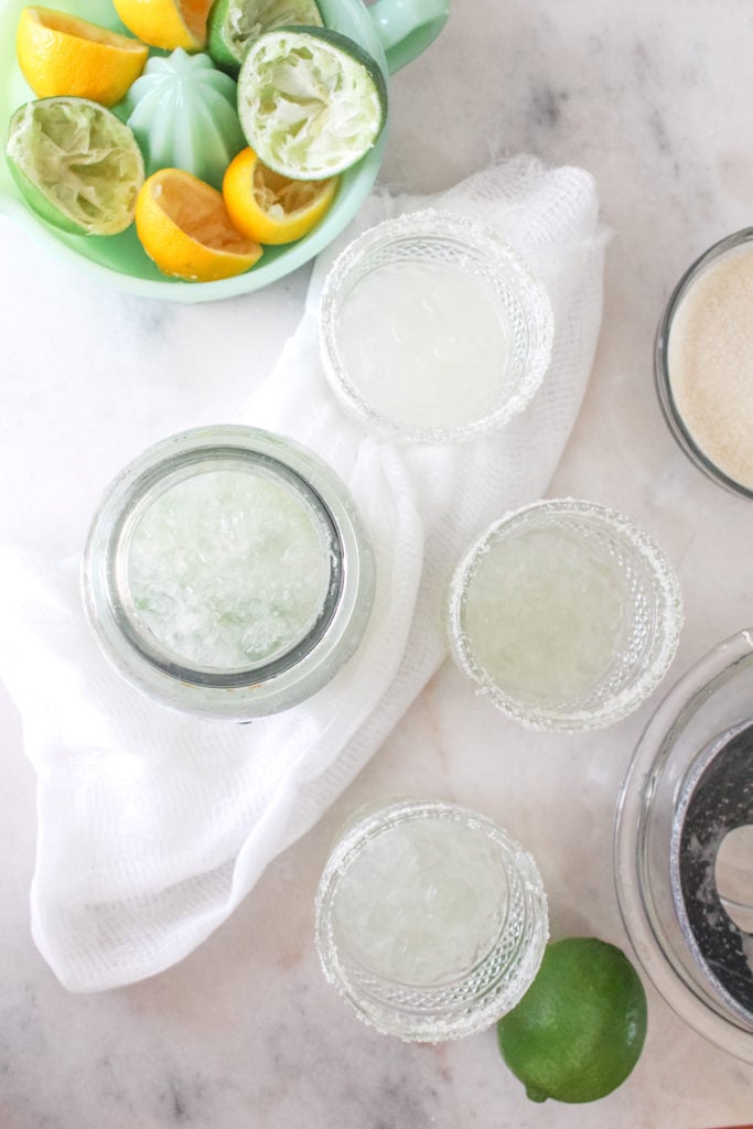 Fresh margaritas in a mason jar made with lime, lemons, tequila, triple sec and plenty of frosty ice.