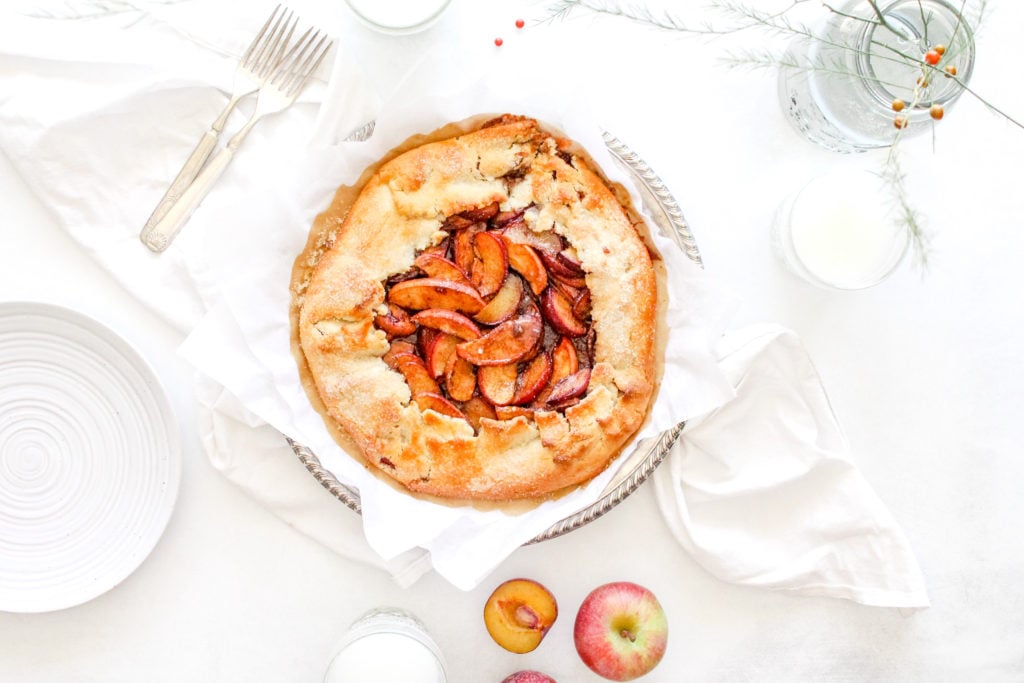 Ninnescah Homestead How to make a gluten free apple galette recipe on a table with white linens, unsliced and fully baked.