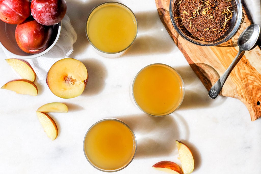 Kombucha and tea leaves and plums styled 