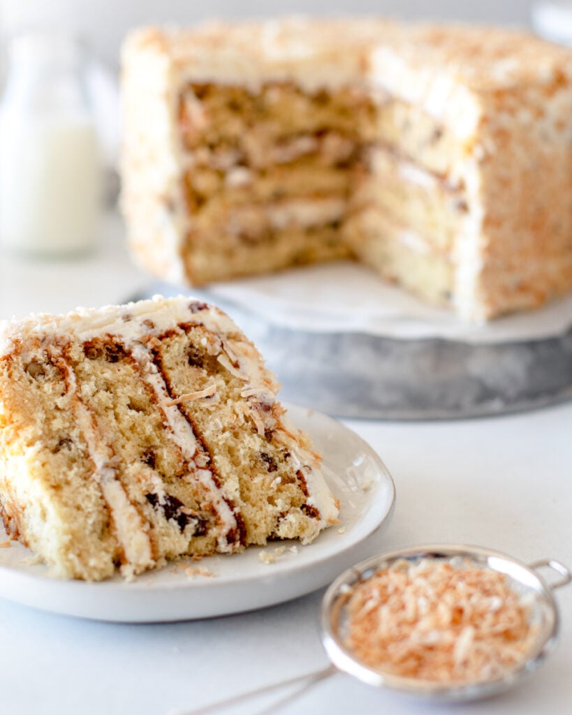 sliced italian cream cheese cake on an aluminum stand