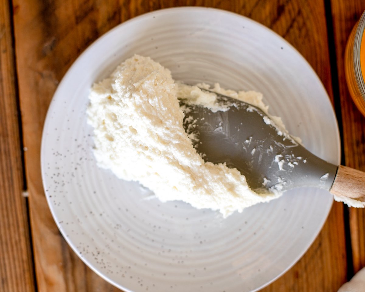 Perfectly creamed butter and sugar that has a light and fluffy texture being shown on a spatula.