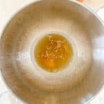 The first step of making marshmallows shows a mixing bowl with warm water and gelatin blooming.