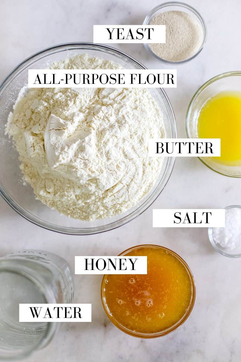 Ingredients for a big loaf of sandwich bread including all-purpose flour, honey, yeast, water, salt and butter.