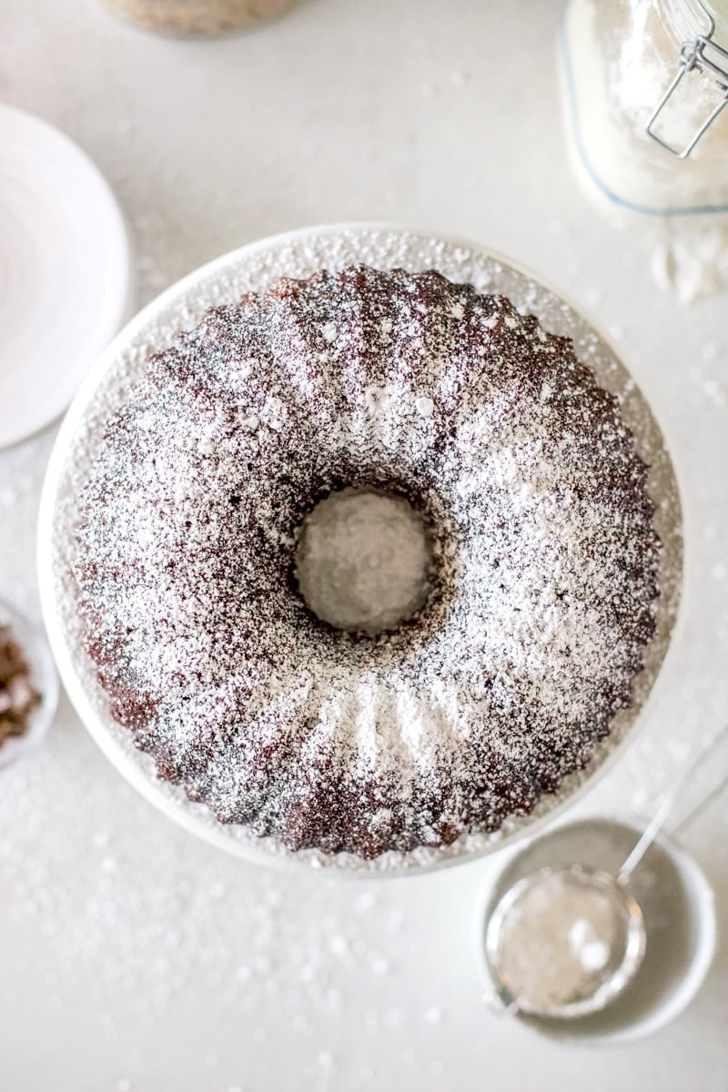 A fudgy sourdough chocolate cake baked in a bundt pan and dusted with powdered sugar.