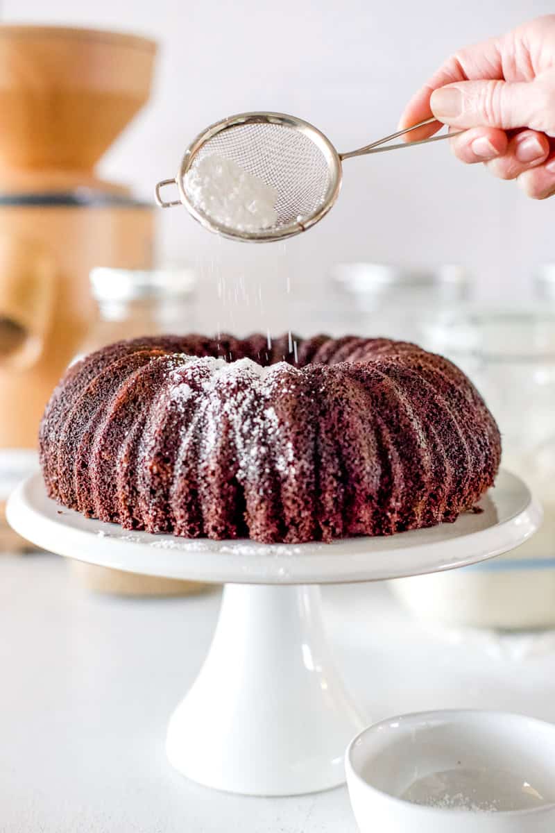 Dust the cooled fudgy sourdough cake with powdered sugar.