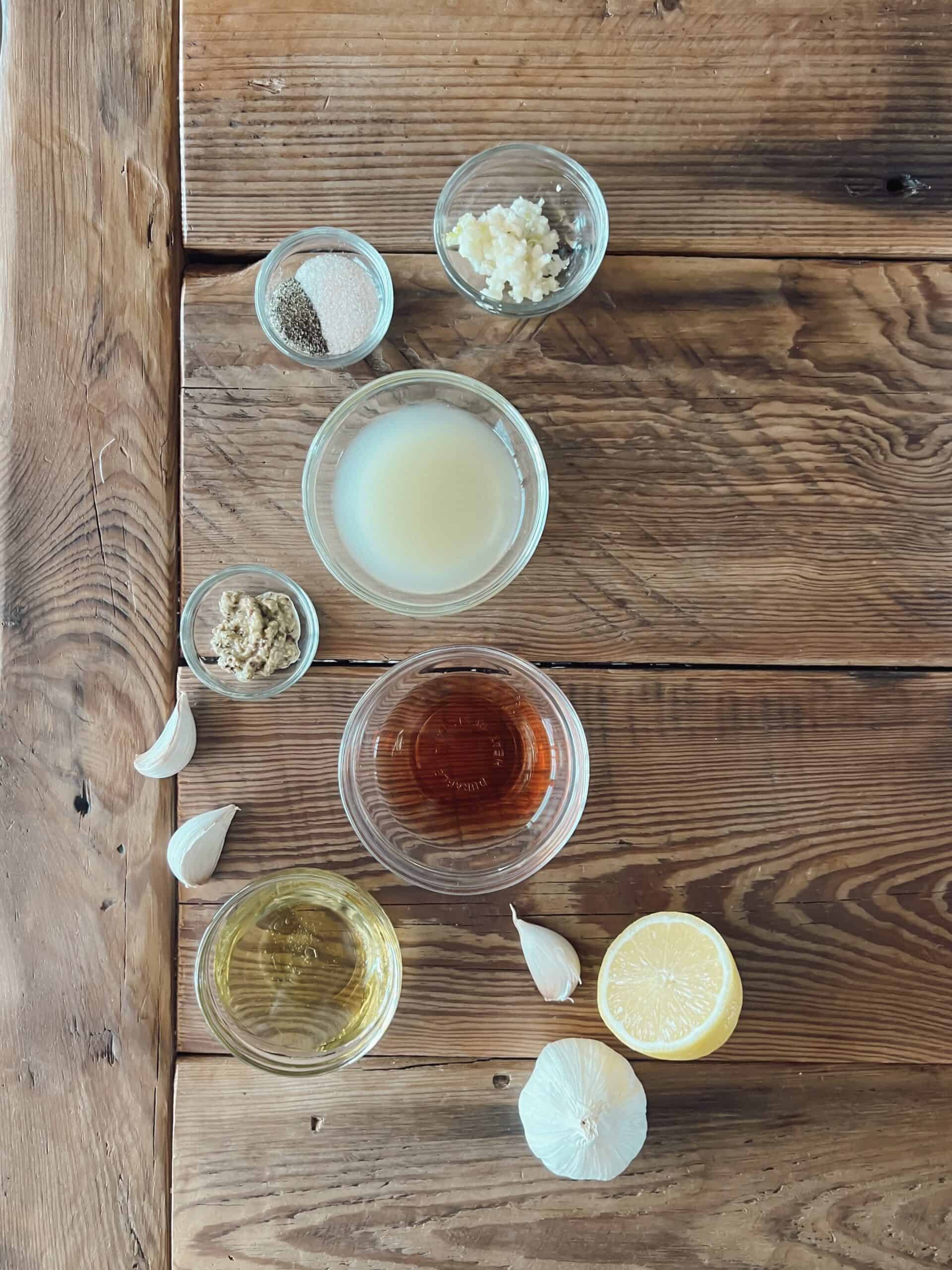 Ingredients for an all-purpose venison marinade including lemon juice, olive oil, garlic cloves, salt, pepper, red wine vinegar and mustard.