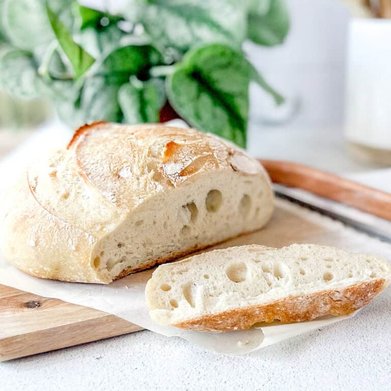 Where is the best place to store bread in the kitchen: a helpful guide with a picture of an artisan sourdough loaf on a cutting board.