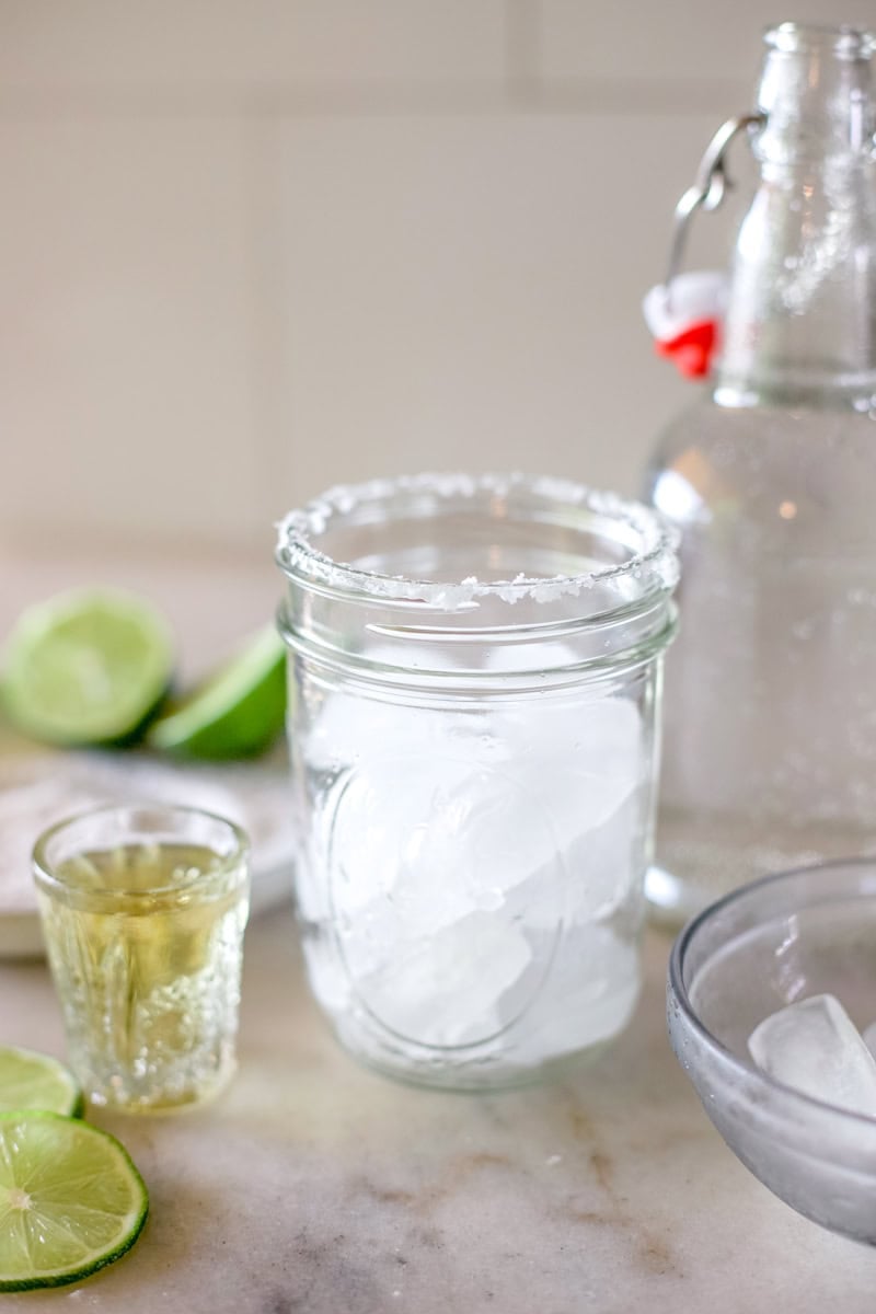 step one for making ranch water, dip the rim in lime juice and add ice to the glass.