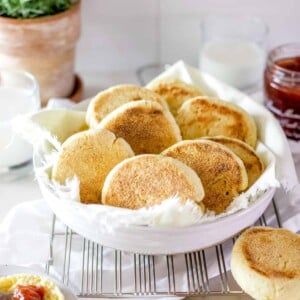 A cover photo of sourdough English muffins in a bowl.