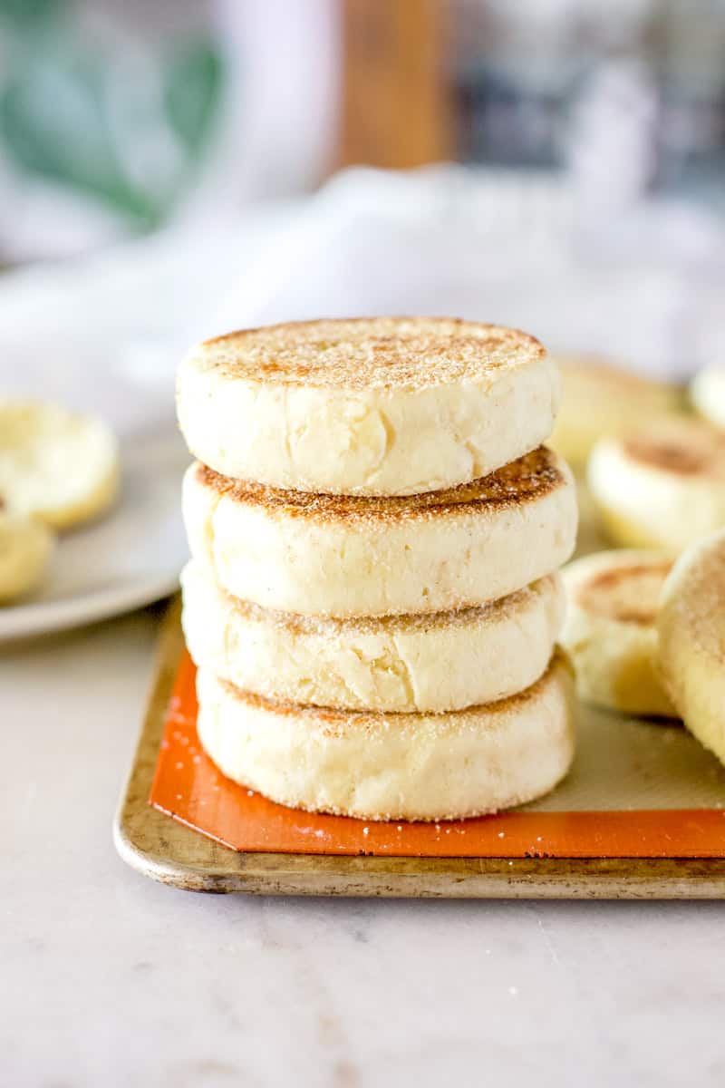 sourdough English muffins on a baking sheet about to be baked.