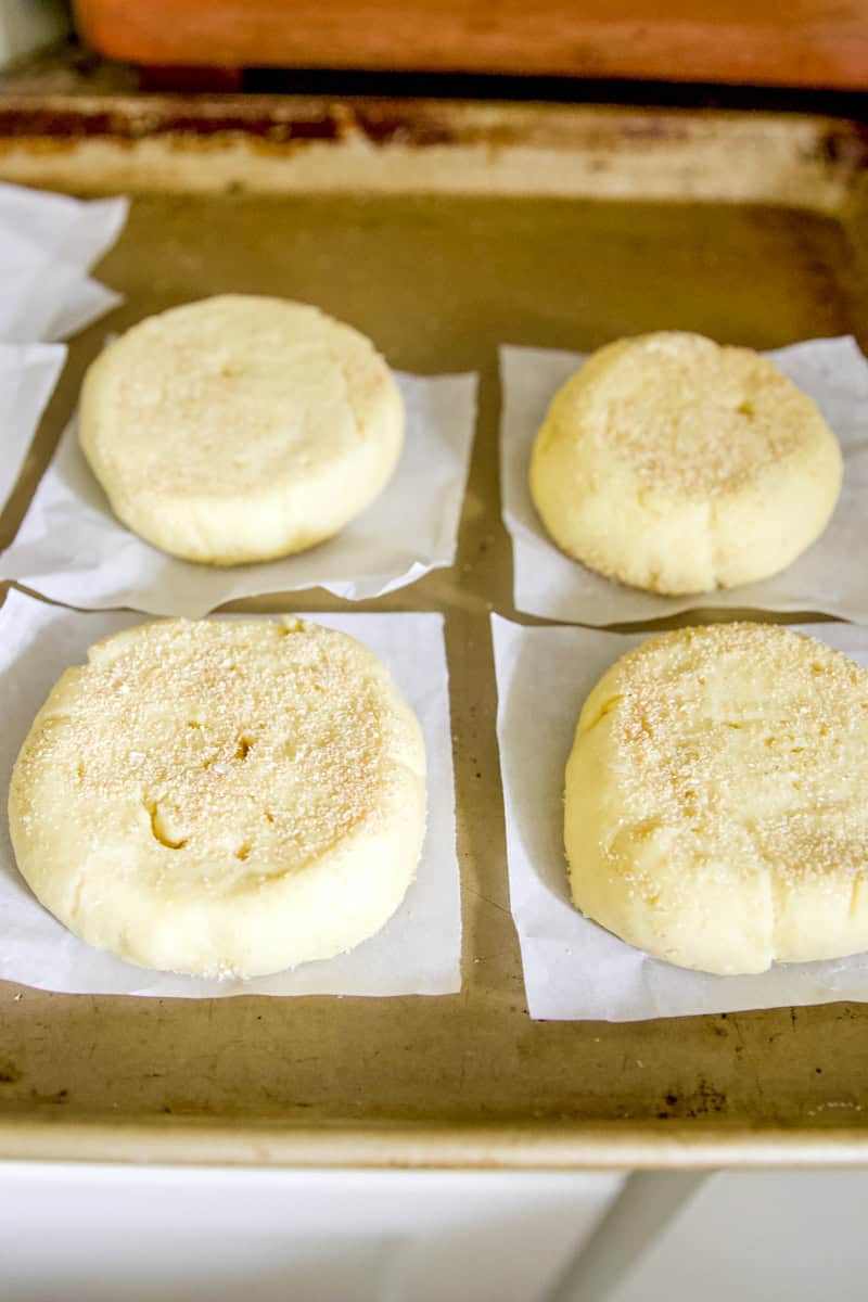 Step 3: cutting parchment paper into 4" squares for keeping the English muffins from sticking on a greased baking sheet.