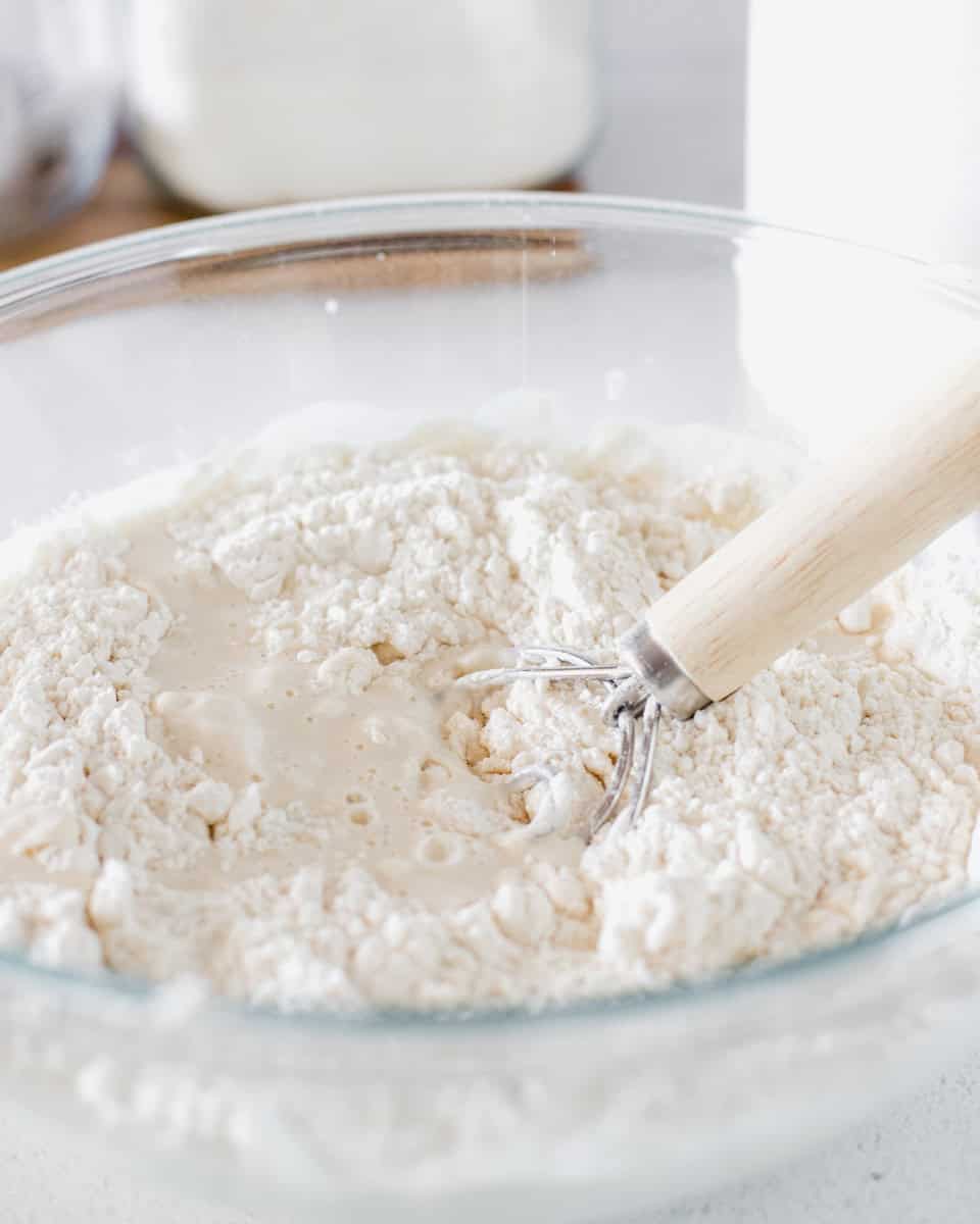 Step one for making English muffins, combine all ingredients in a bowl and knead.