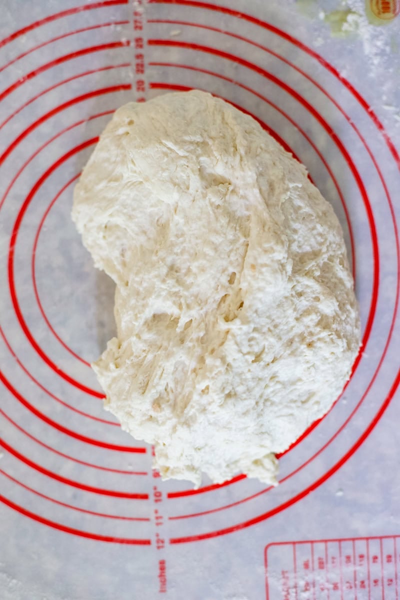 Step 3 of making a sourdough baguette is kneading the dough until it is well mixed.
