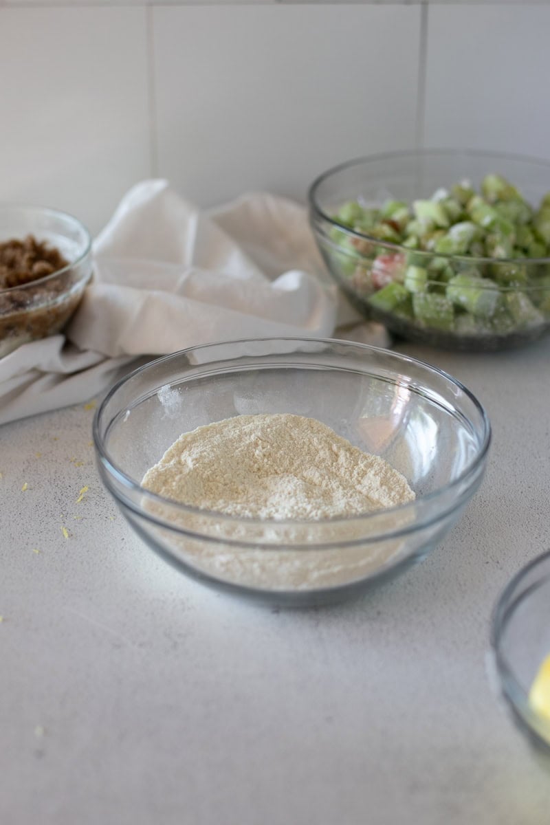 Step two of making a sour cream cake is mixing the dry batter ingredients together in a bowl and setting aside.