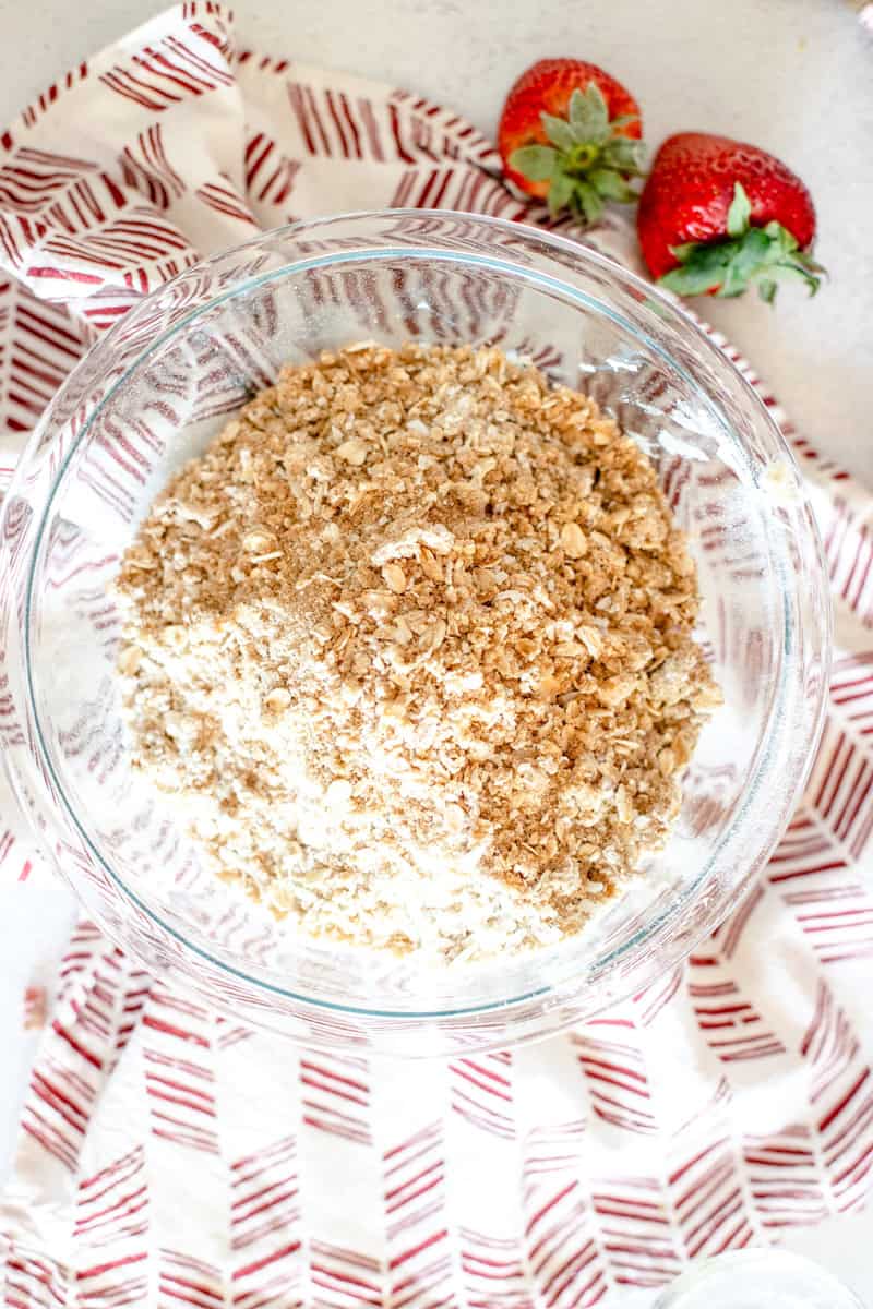 Step two of making a strawberry rhubarb crisp is mixing the streusel ingredients in a bowl.