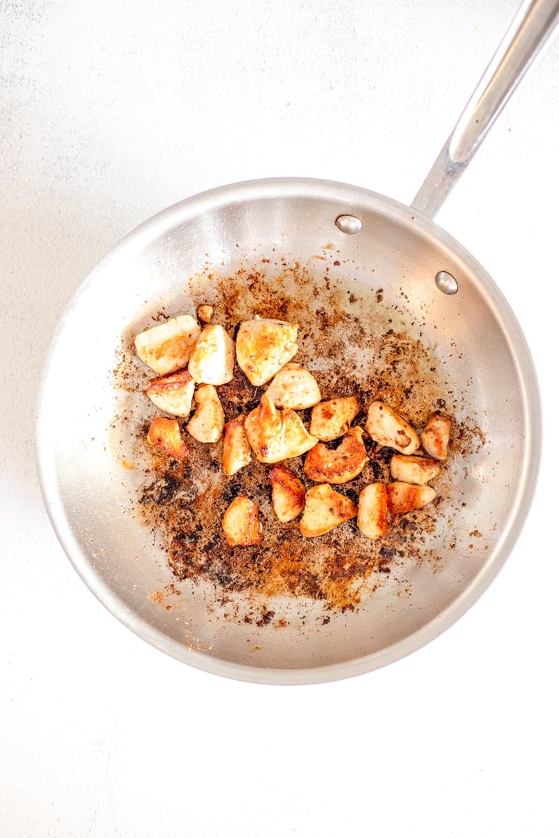Step one of making Loaded Marry Me Chicken pasta is cooking the chopped chicken in a skillet.