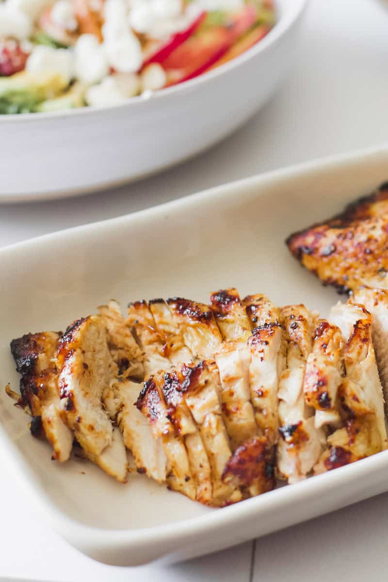 step two of making a strawberry smash salad with chicken is slicing the grilled or cooked chicken.