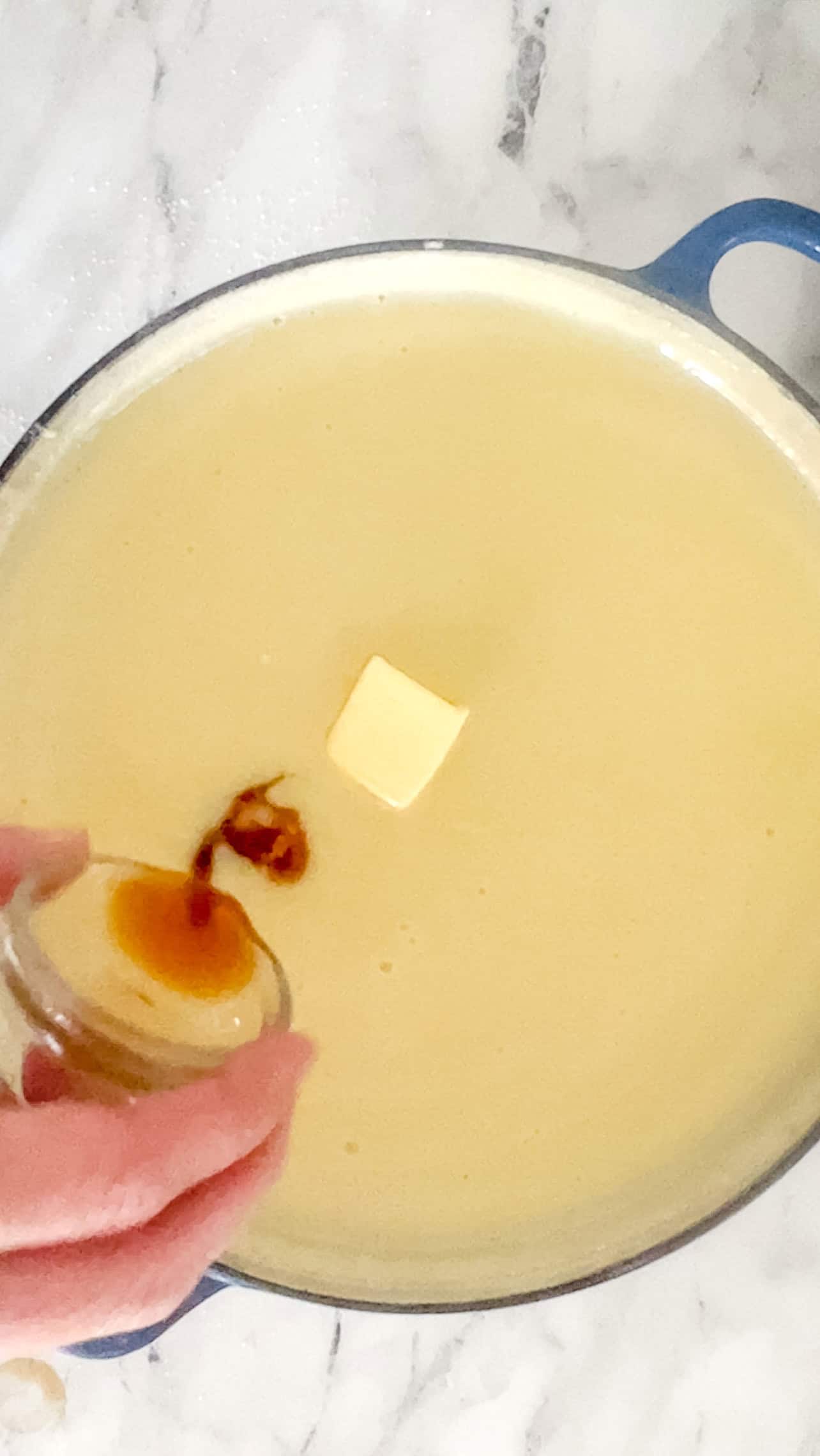 Step three of making homemade vanilla pudding is adding the butter and vanilla to the cooked pudding.