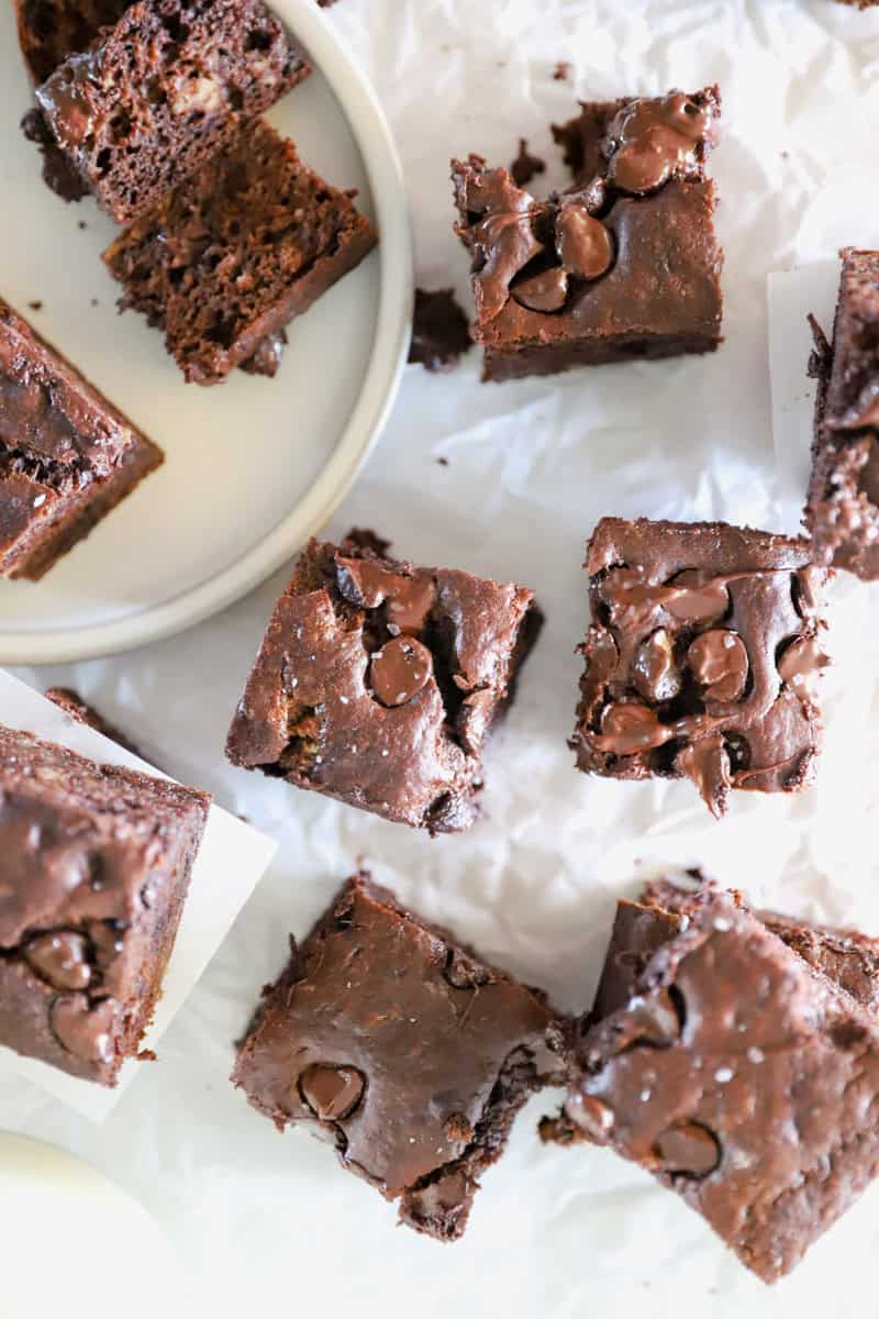 A top view of sourdough discard chocolate banana bread bars on a white parchment.