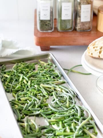 How to preserve food with a freeze dryer showing an image of garlic scapes on a freeze dryer tray.