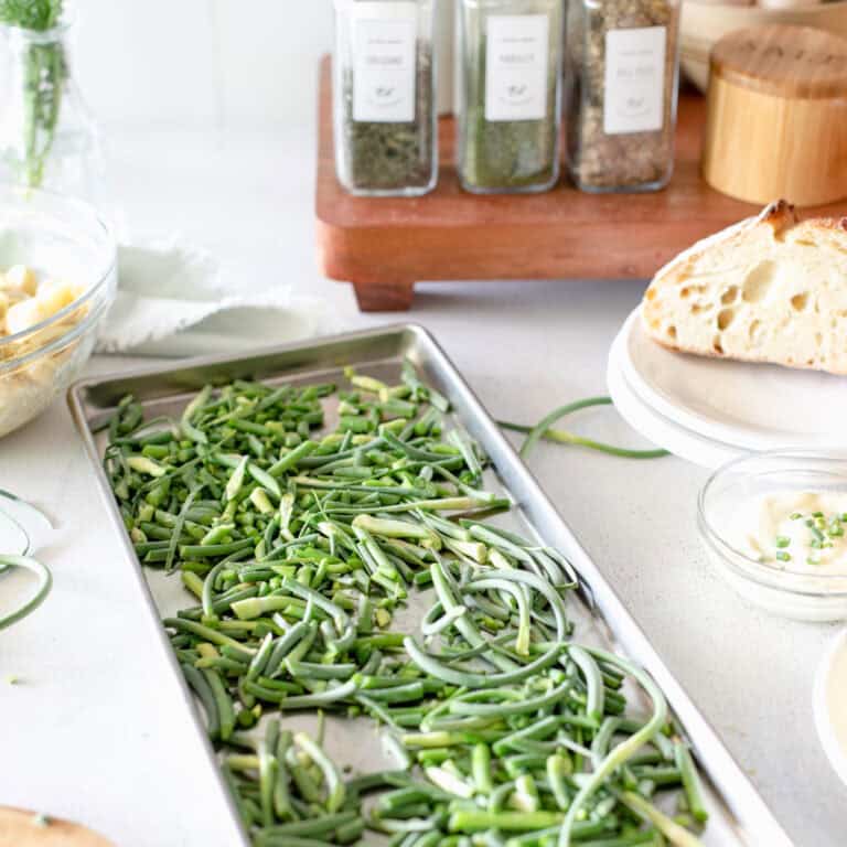 How to preserve food with a freeze dryer showing an image of garlic scapes on a freeze dryer tray.