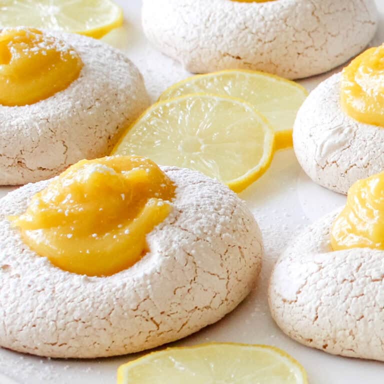 Little lemon meringue lemon curd cookies with powdered sugar.