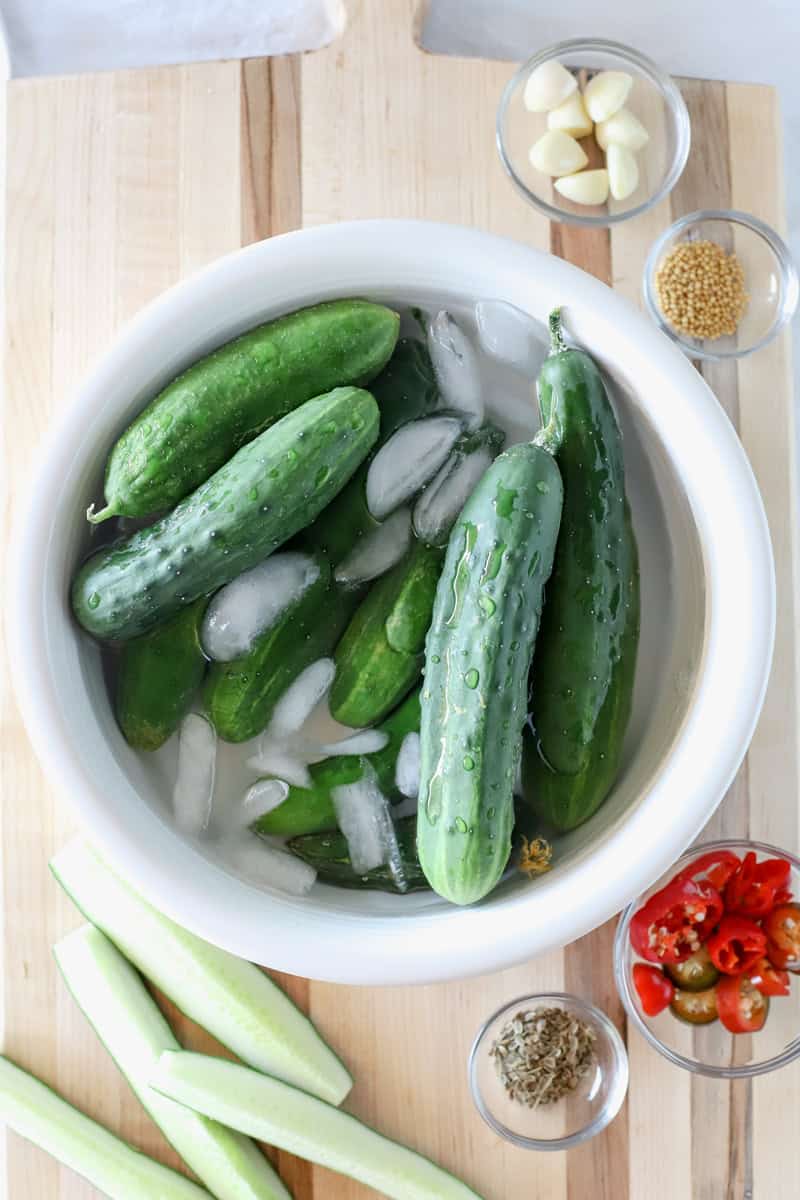 Step 1 of making pickles: Prepare the cucumbers by washing them thoroughly under cool running water and trim off the ends if desired, I recommend soaking the pickles for thirty minutes in a sink or bucket filled with ice water before starting this recipe.