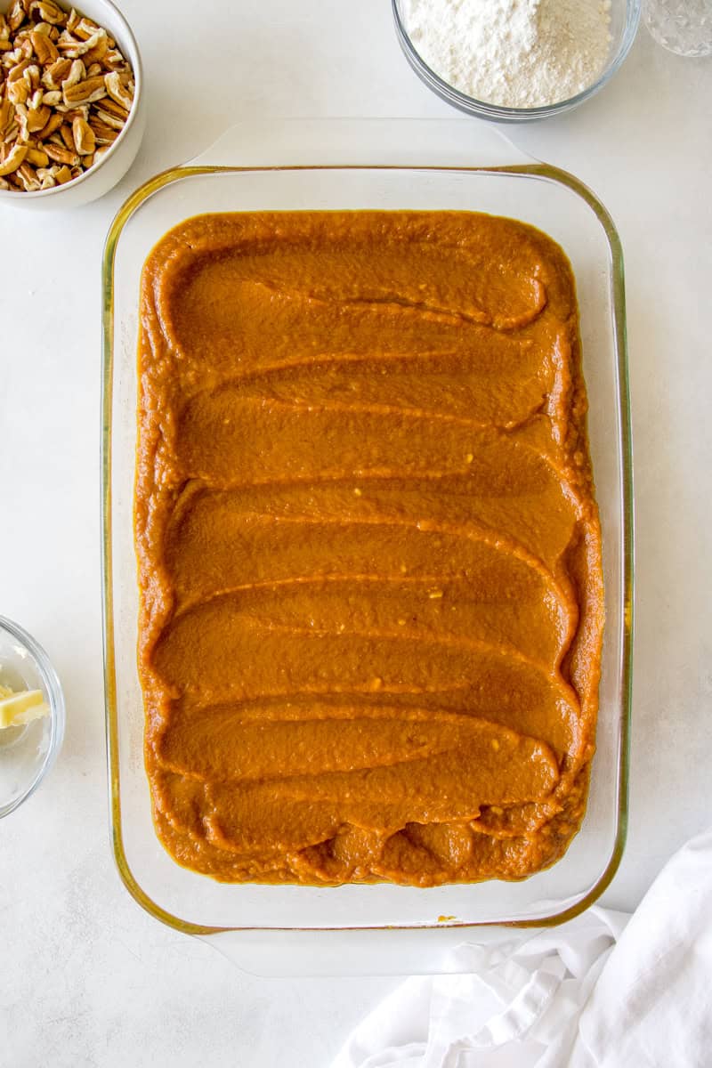Use the same mixing bowl to combine the canned pumpkin, three eggs, pumpkin pie spice, milk and 1 cup of sugar. Whisk it well, then pour the pumpkin mixture over the bottom layer.