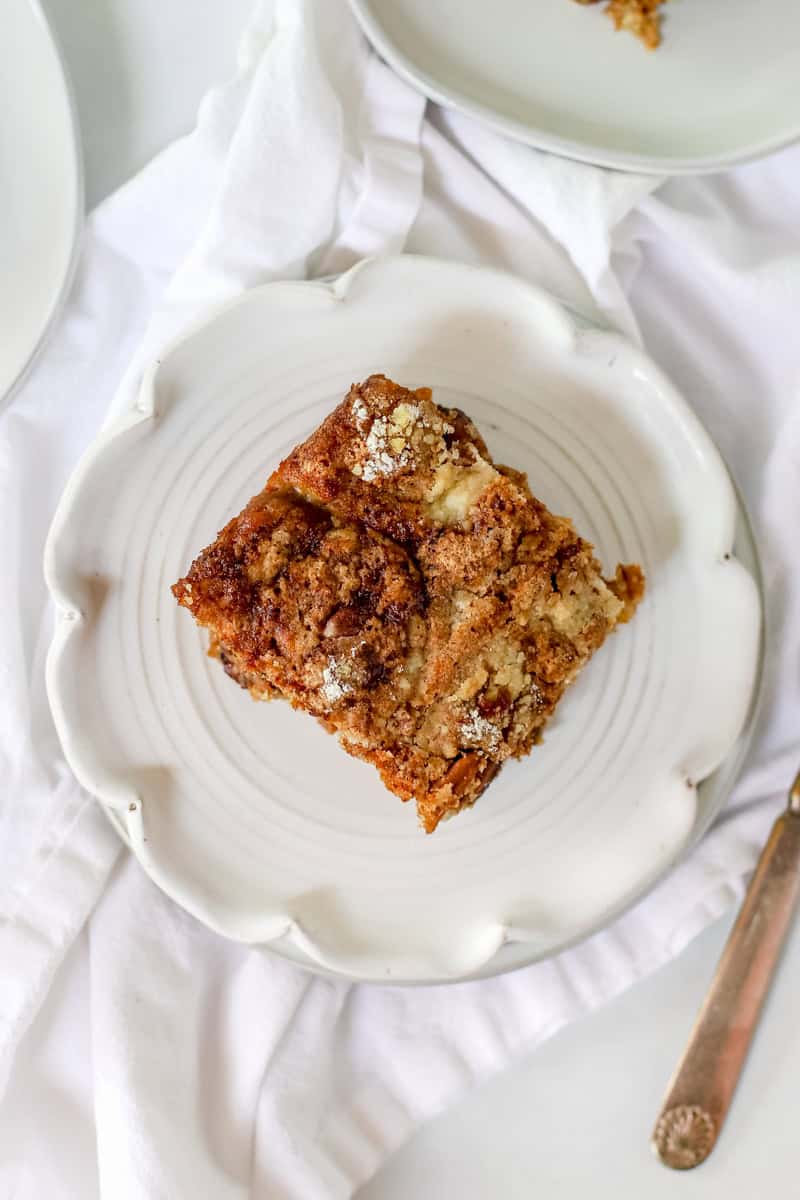 A slice of pumpkin crunch cake on a white plate.