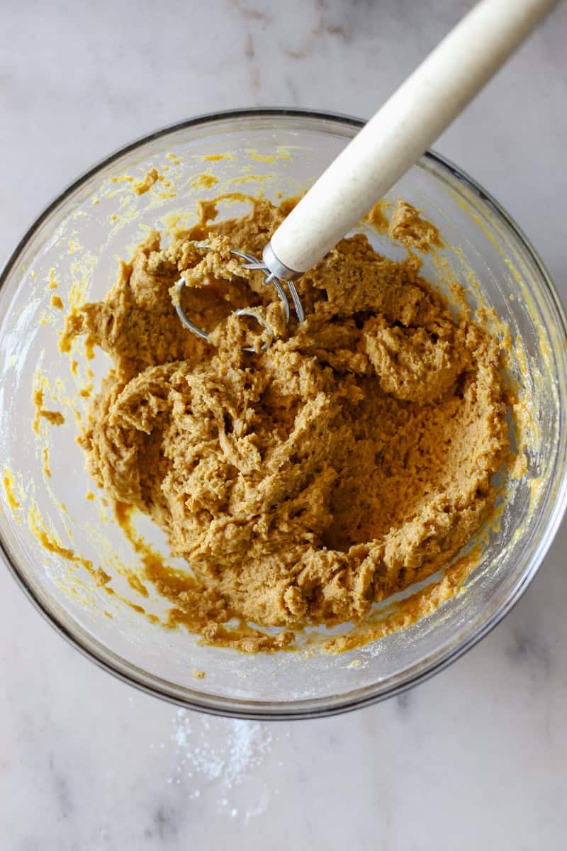 Step three of making baked pumpkin spice donuts is mixing together the wet and dry ingredients.