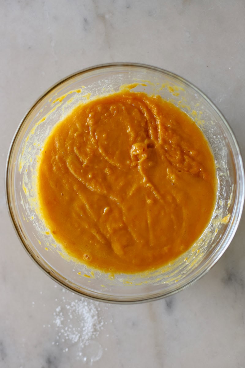 step two of making pumpkin donuts is mixing the wet ingredients in a bowl until well combined.