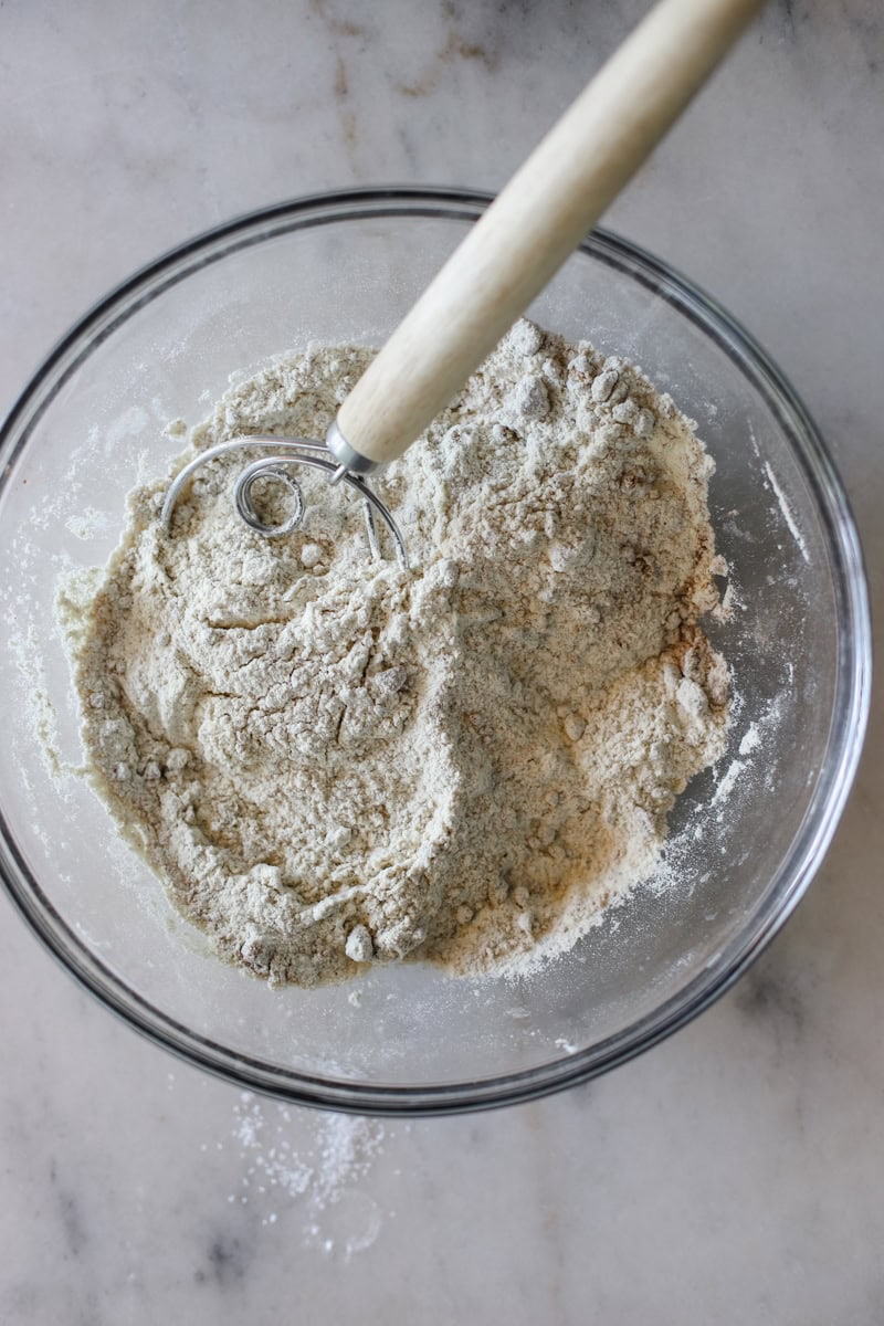 Step 1 of making pumpkin spice donuts is mixing the dry ingredients and preheating the oven.