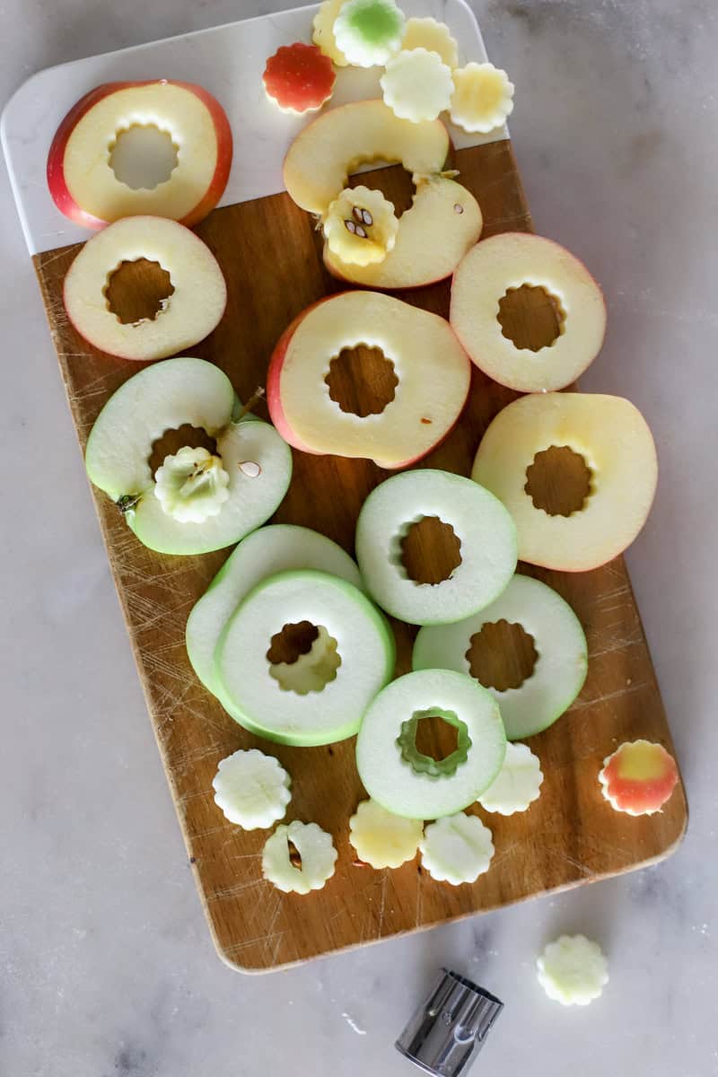 Step 2 of making an apple puff pastry appetizer is  Cut the apples into slices and remove the seeds with a cookie cutter or knife.