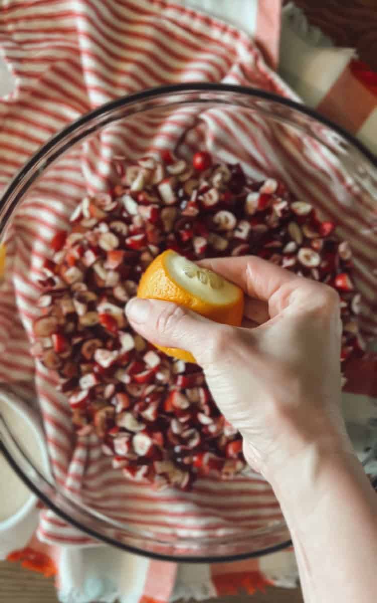 Step 3 is tossing the cranberry pieces with sugar and orange juice.