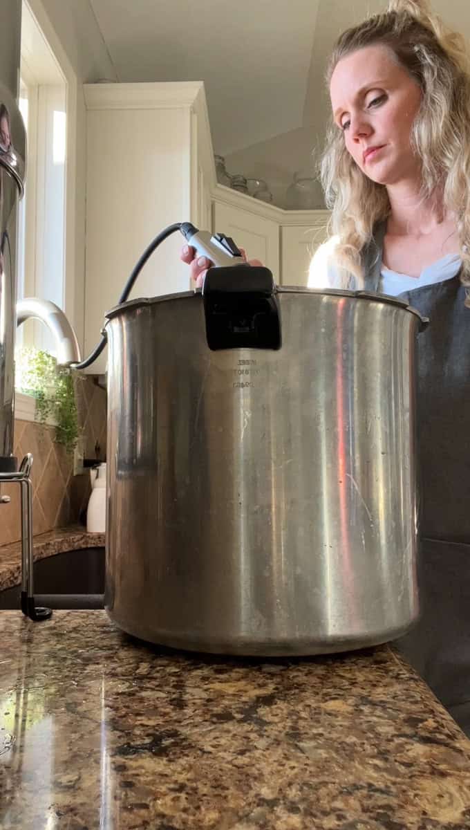 Step 3 of canning cranberry juice is filling the canner and washing the jars.