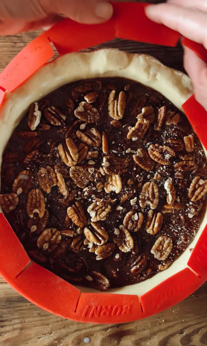 Step three of chocolate pecan pie is covering the crust.