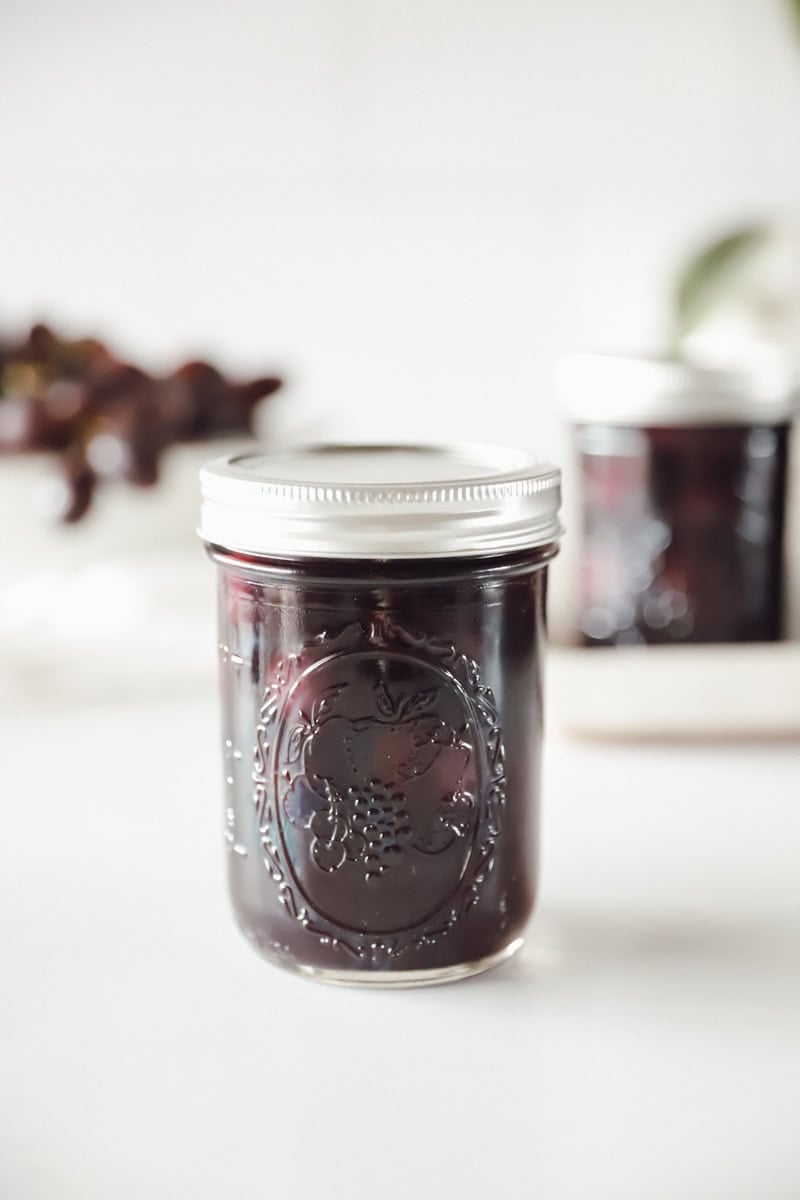 A processed canning jar of grape juice.