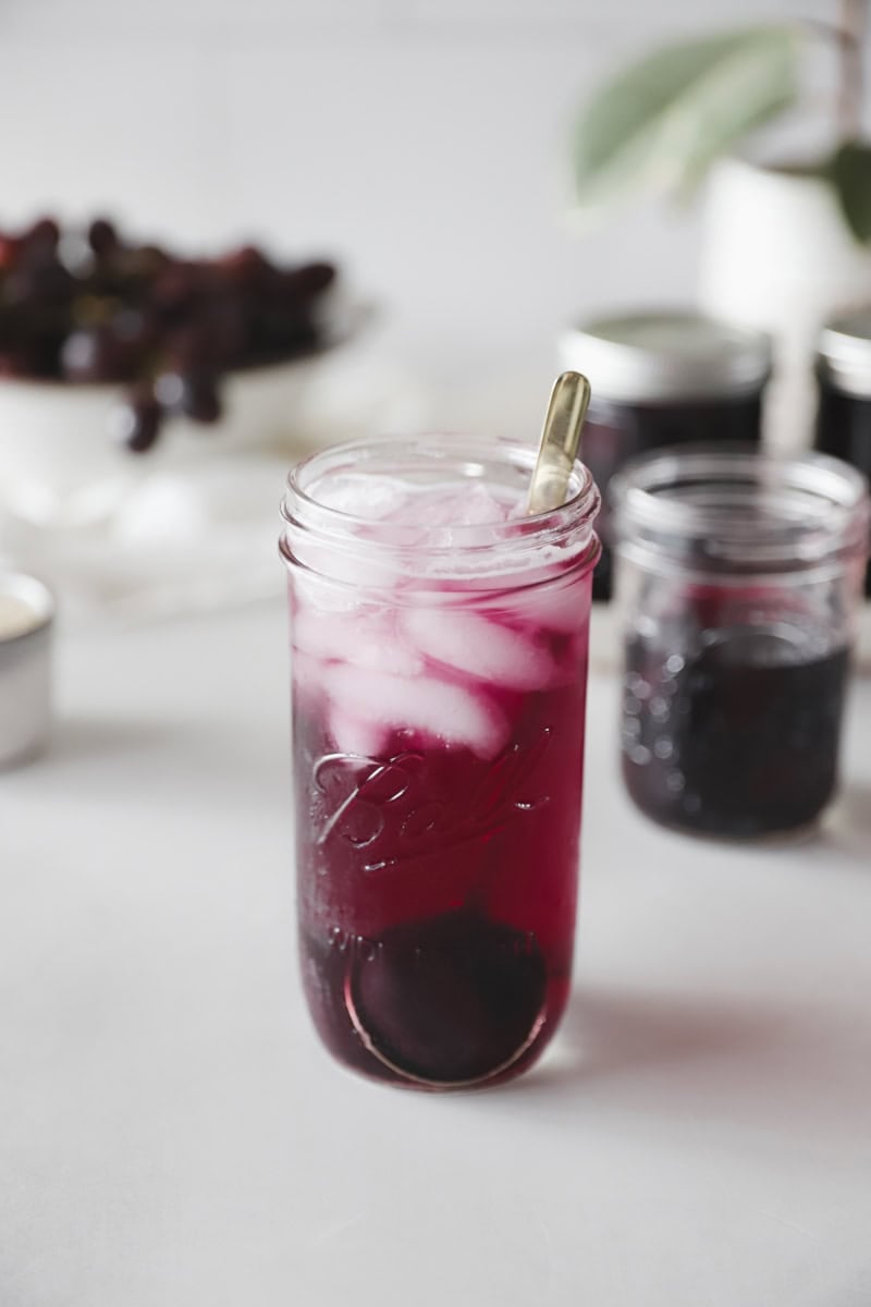 A serving suggestion of how to serve grape juice is adding ice cubes and sparkling water to make a homemade grape soda.