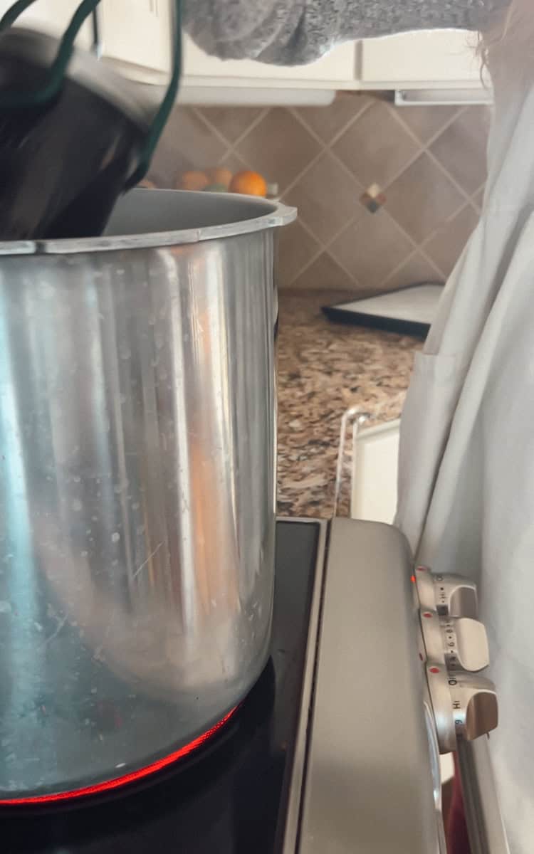 Step 3 of making grape juice is putting the jars in the canner.