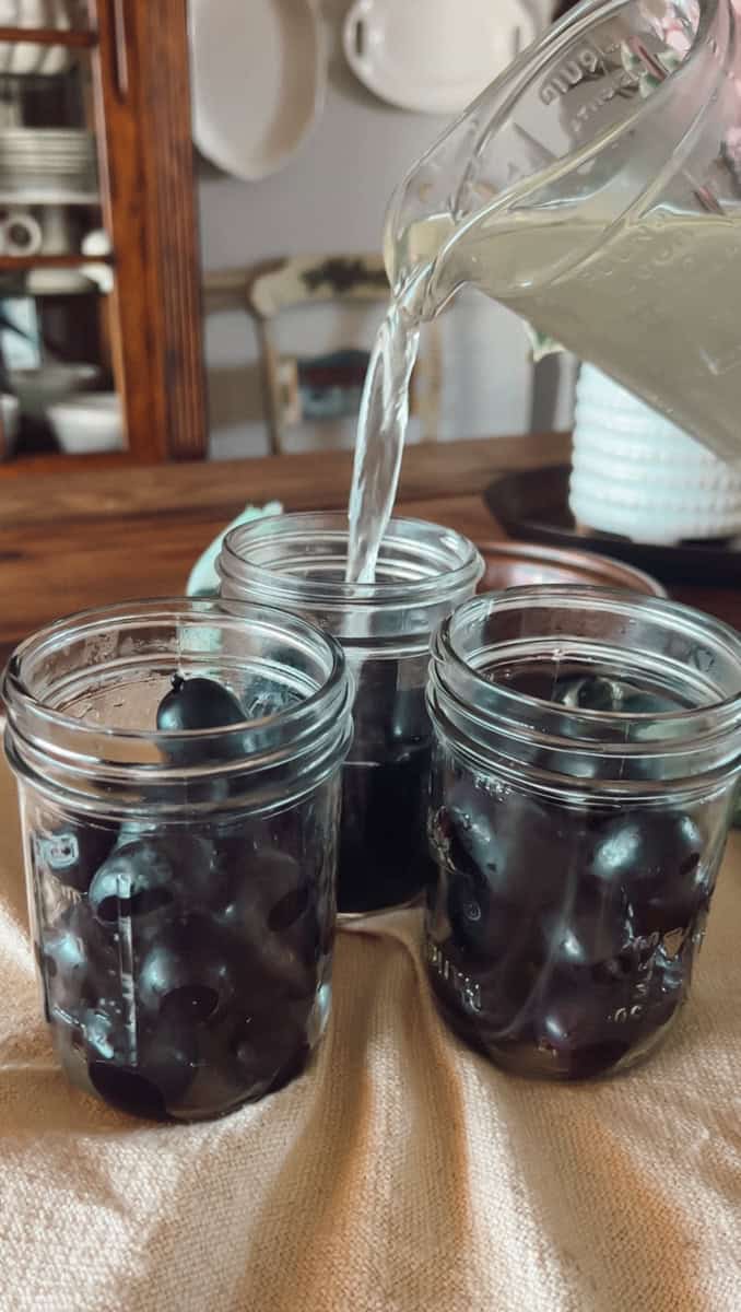 Step 2 of making grape juice is prepping the jars, filling the jars and wiping the rims.