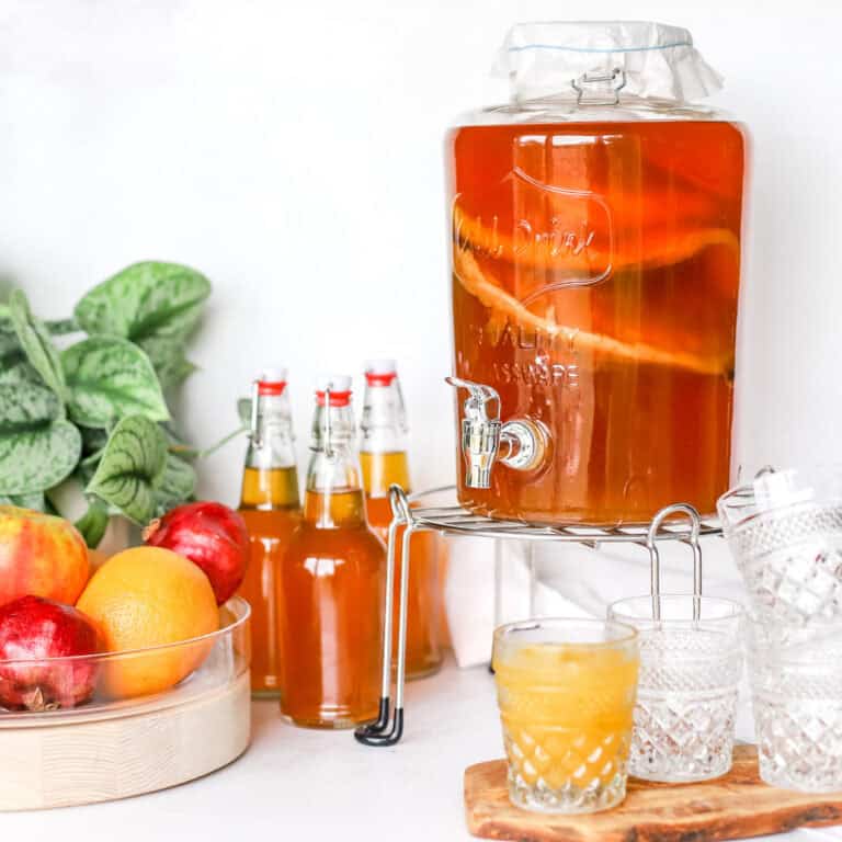 A glass beverage dispenser filled with continuous brew kombucha for a blog post sharing How to Make Kombucha Starter Tea.