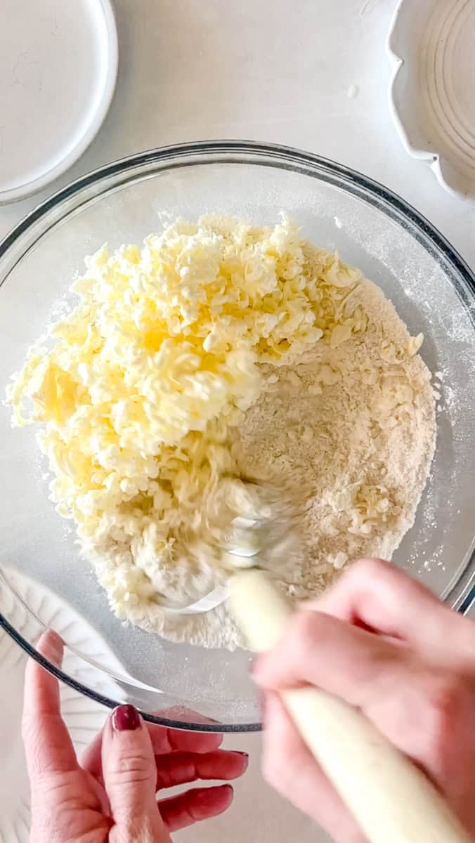 Step 3 of making sourdough scones is use a pastry cutter to cut the butter into the dry ingredients until it resembles coarse sand.