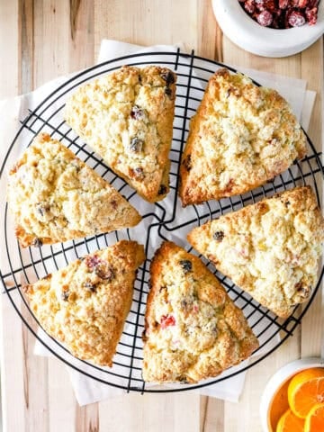 Top view of cranberry orange sourdough scones on a wire rack.
