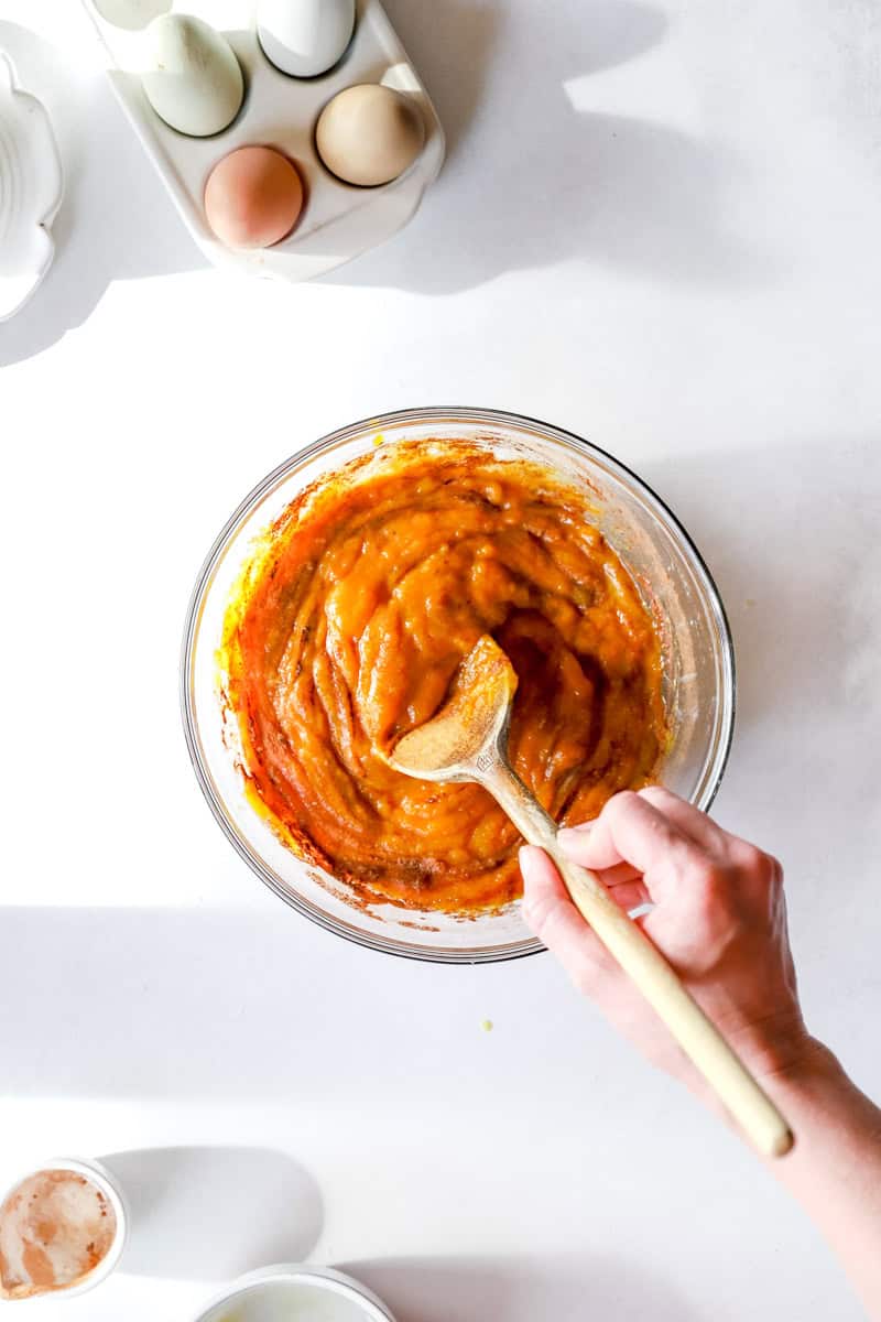 Step 2 of making a pumpkin pie is stirring the filling ingredients together in a large mixing bowl.