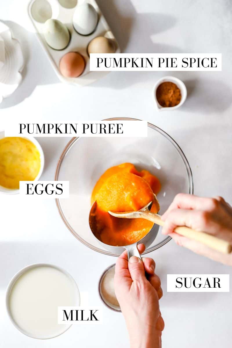 A top view of ingredients for pumpkin pie that shows a woman pouring pumpkin puree into a bowl.