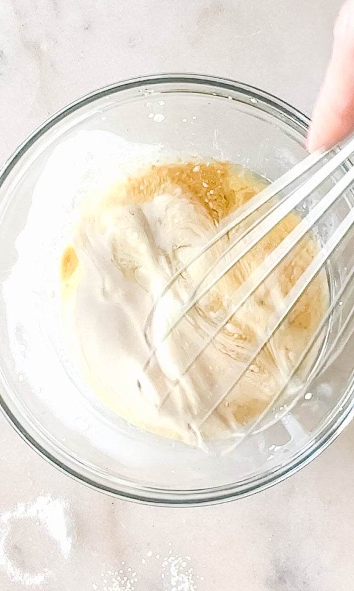 Step 3 of making a sourdough pie crust is mixing in the honey and starter to the flour mixture.
