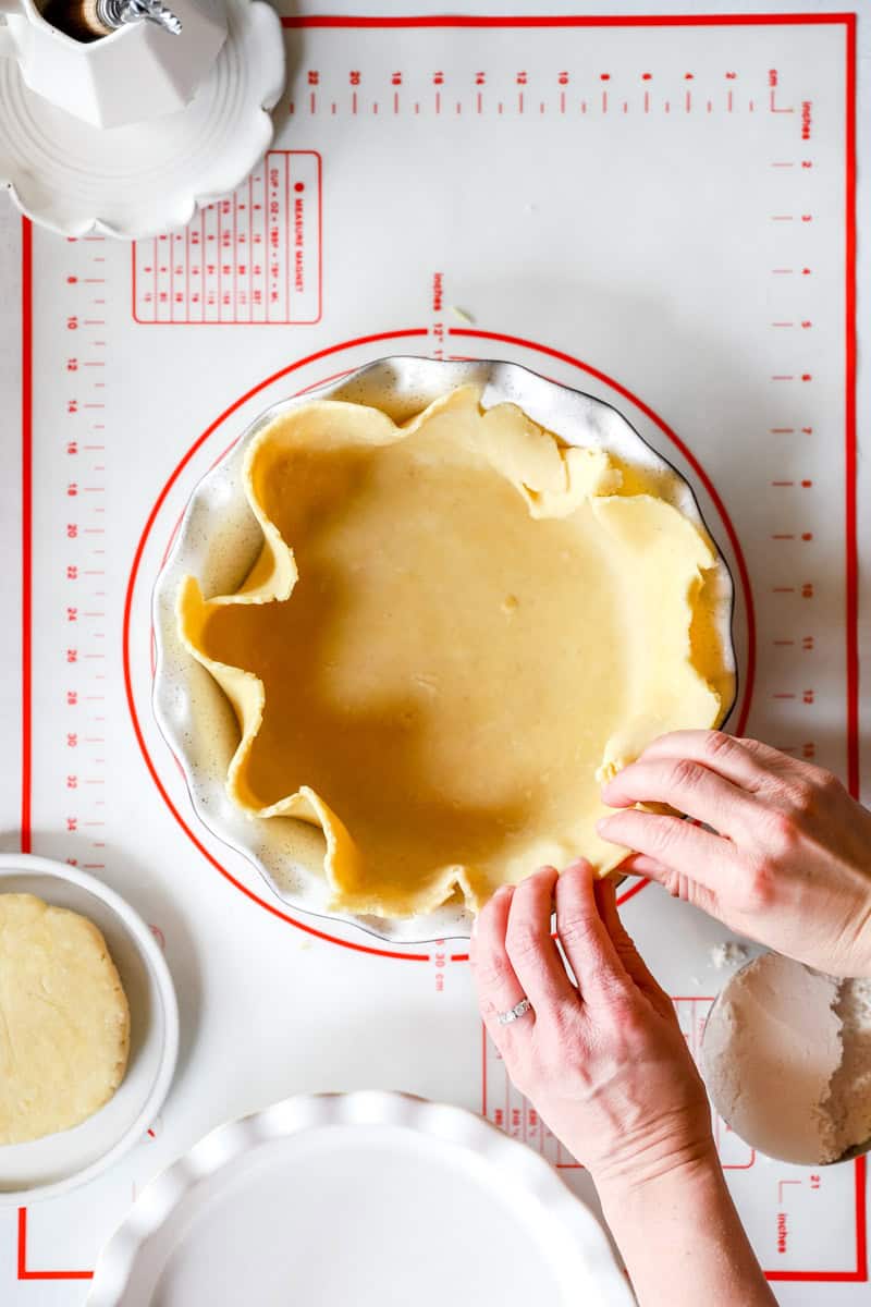 Shaping the edges of a sourdough pie crust.
